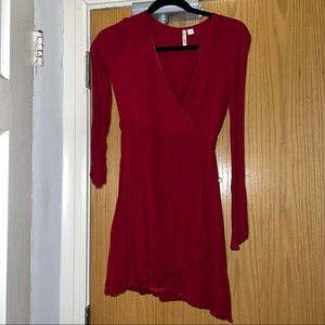 Red long sleeve faux wrap style dress.